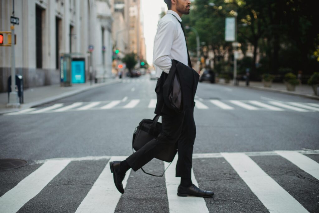 man walking across street